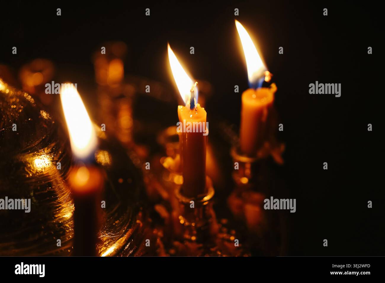Bougies commémoratives allumées dans l'intérieur sombre de l'église. Symbole du souvenir, de la prière, de la foi et du concept de réflexion spirituelle. Banque D'Images