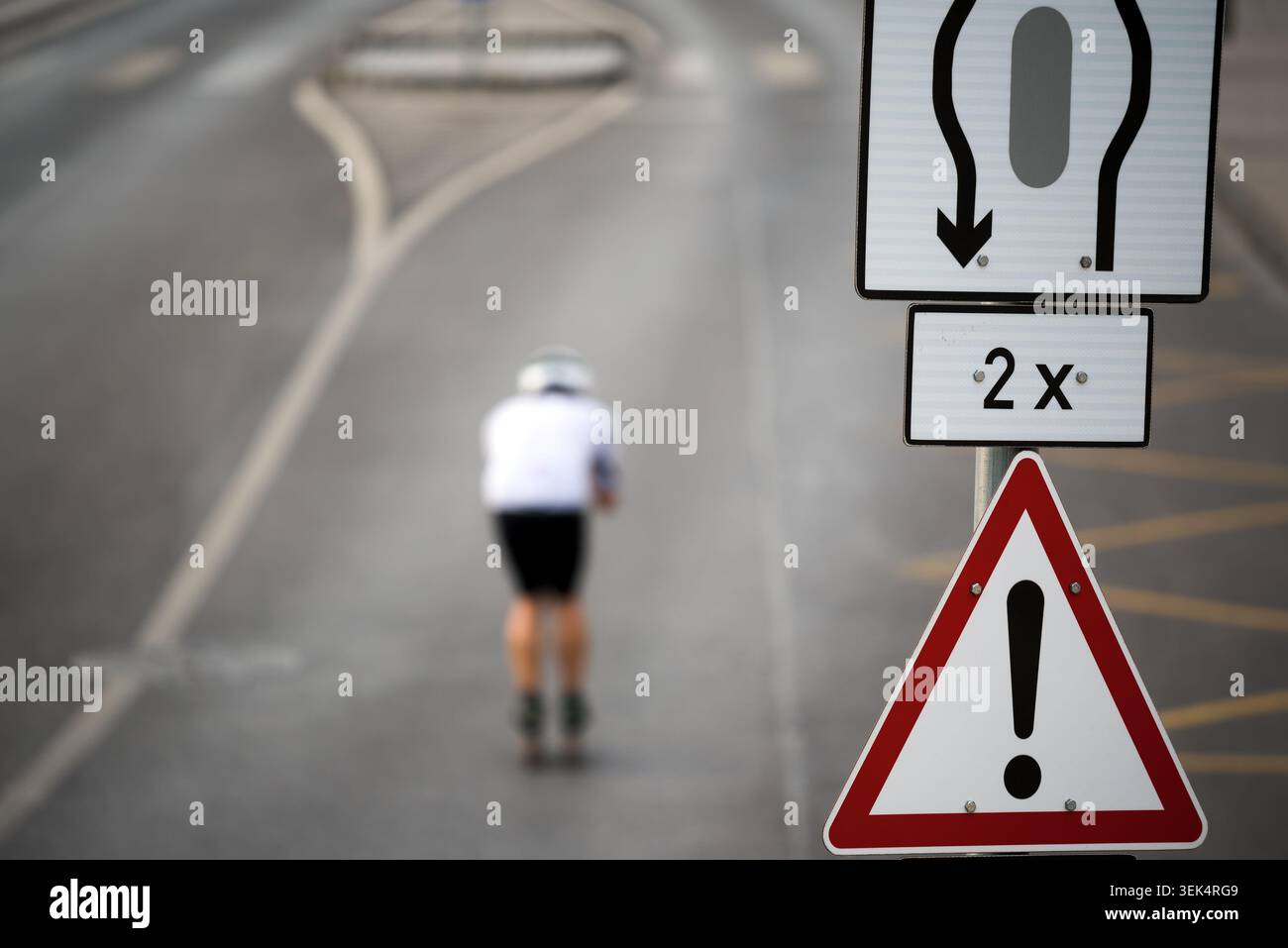 Panneau de signalisation sur la route, ski défocalisé à roulettes en position de repli Banque D'Images