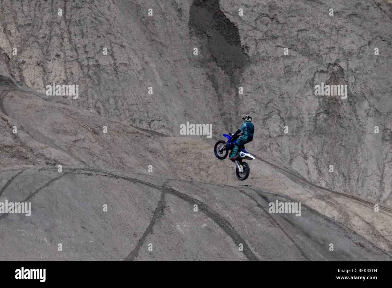 Cavalier sur un vélo tout-terrain sautant dans la région de Swing Arm City OHV, Caineville, Utah. Banque D'Images