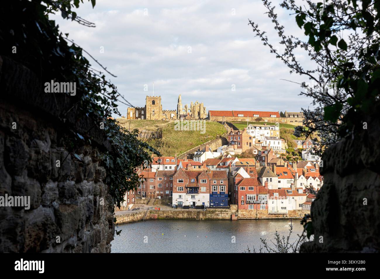 Whitby, Yorkshire, Royaume-Uni, Angleterre, Une vue encadrée donnant sur une vieille fosse murée de pierre à travers le port supérieur vers la falaise est à Whitby. Le Banque D'Images