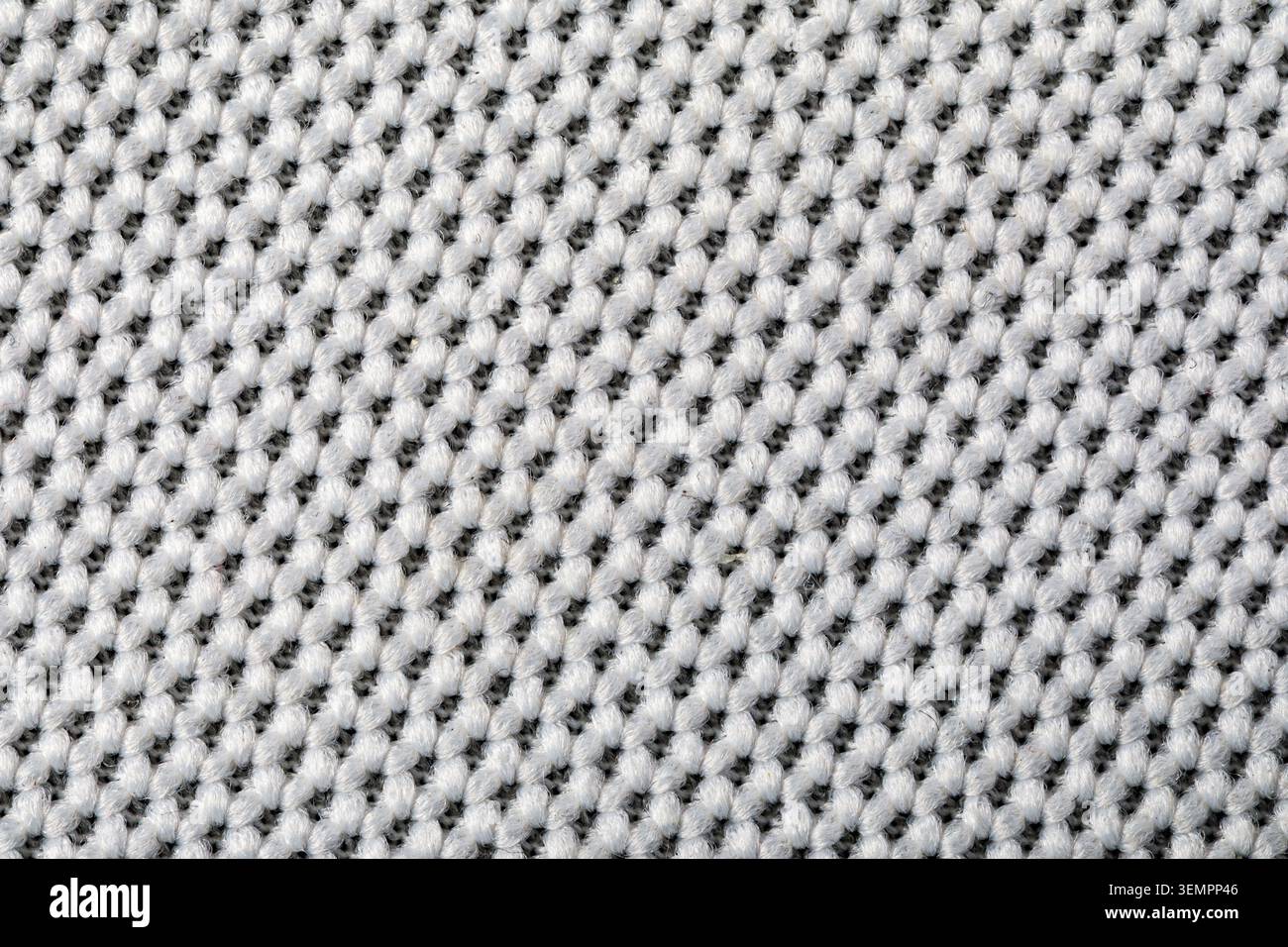 Tricot blanc affichant une texture de matériau tissé détaillée Banque D'Images