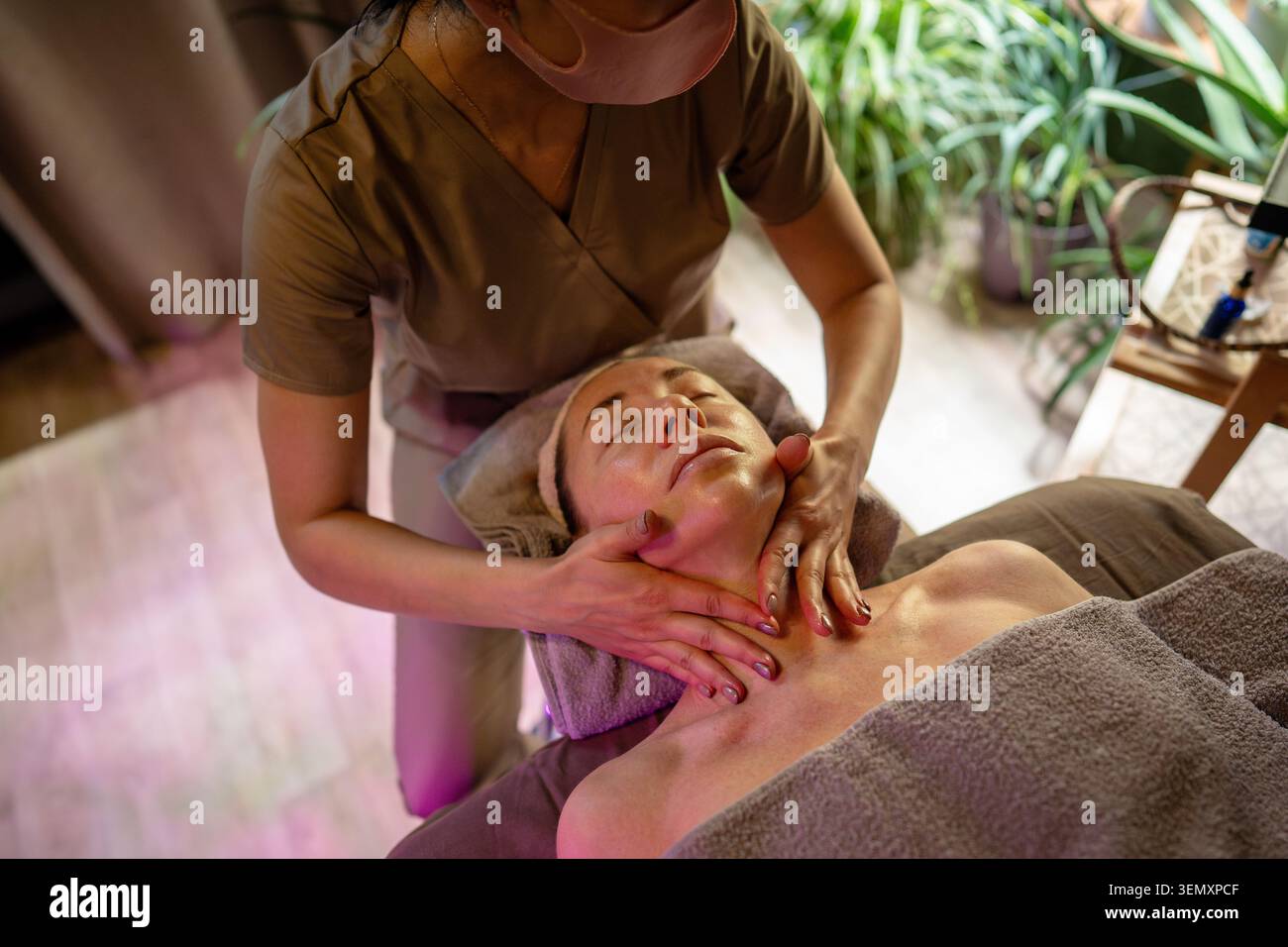 Client de femme de rêve obtenant un massage facial de levage spécial dans un salon de spa de luxe de cosmétologue. Banque D'Images