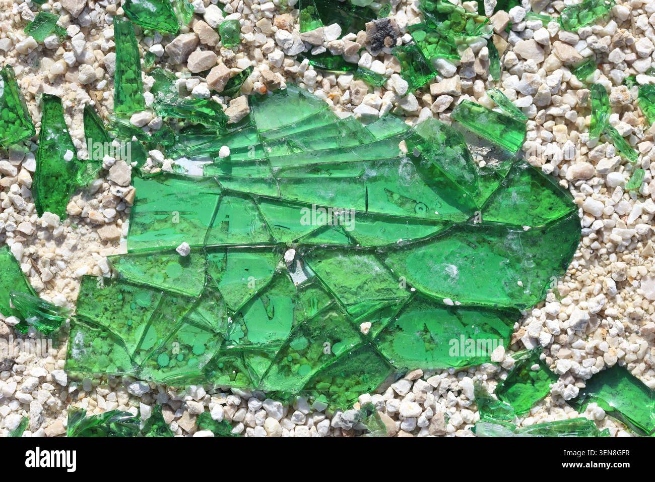 Titre vue de dessus de fragments de verre vert brisé et de fragments mélangés à de petits cailloux de gravier blanc Banque D'Images