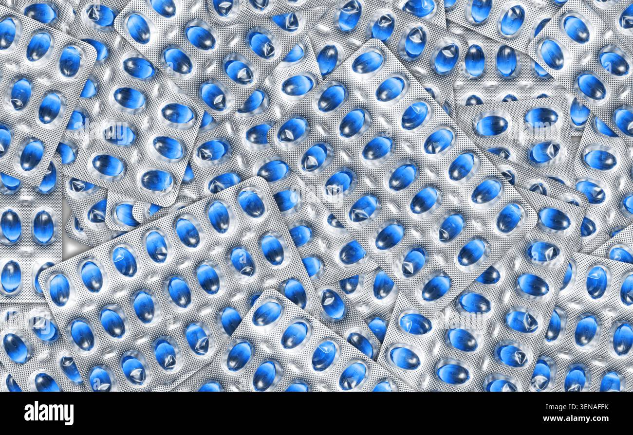 Capsules bleues dans des blisters formant un motif médical de fond. Médicament pharmaceutique et concept de traitement de santé. Banque D'Images