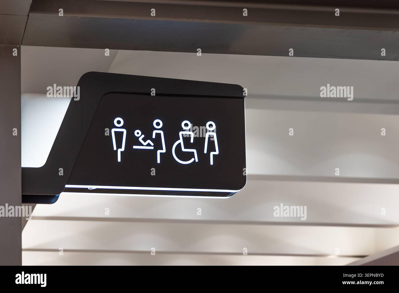 Panneau lumineux des toilettes publiques avec icônes inclusives Banque D'Images