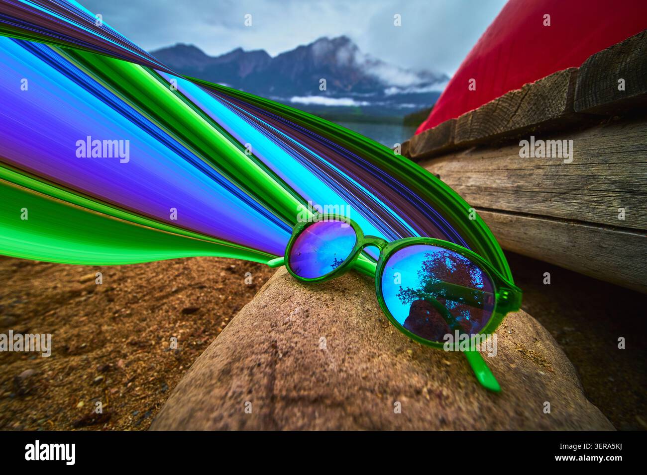 Lunettes de soleil réfléchissantes sur la rive du lac avec effet Pixel Stretch et fond de montagne Banque D'Images