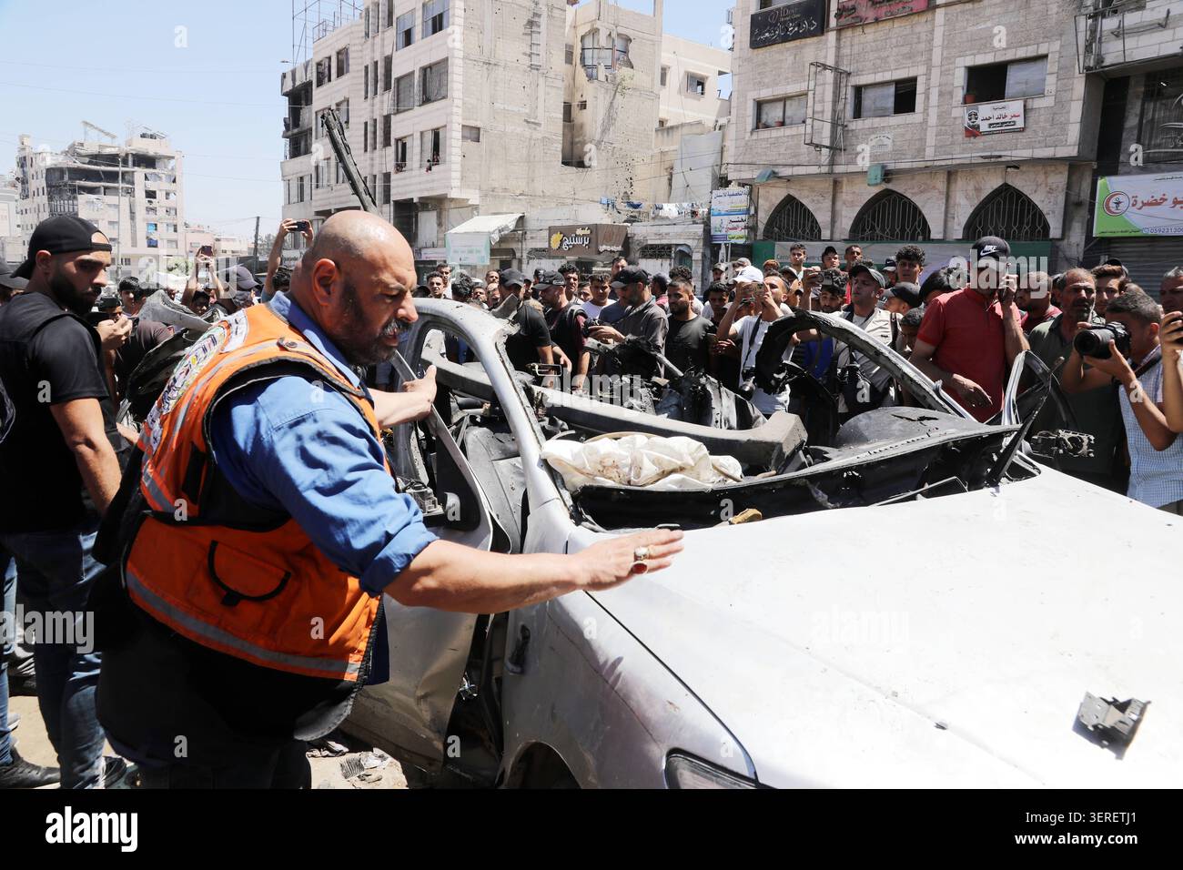Les Palestiniens se rassemblent sur le site de la grève meurtrière de véhicules dans la ville de Gaza les Palestiniens et le personnel de la défense civile se rassemblent autour d’un véhicule détruit qui a été pris pour cible lors d’une frappe aérienne israélienne dans la ville de Gaza, le 18 juin 2026. La frappe a tué trois Palestiniens, selon des sources médicales, et a causé d'importants dégâts au véhicule. Photo de Belal Osama apaimages Gaza bande de Gaza territoire palestinien 180626_Gaza_BO_1_0047 Copyright : xapaimagesxBelalxOsamaxxapaimagesx Banque D'Images