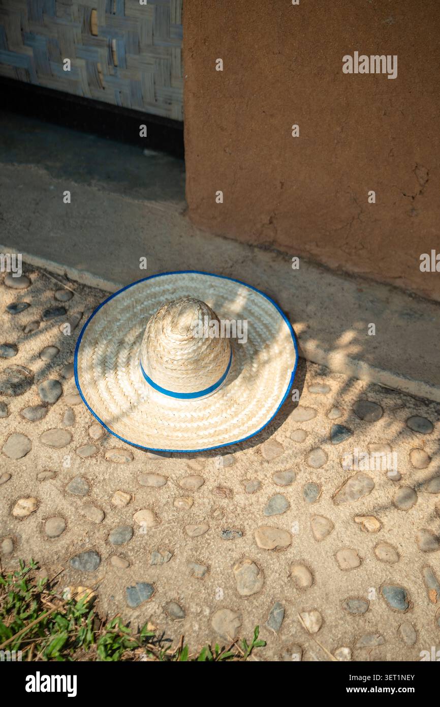 Accessoire d'été populaire pour homme et femme chapeau naturel fait de pailles couchées sur le sol à l'extérieur. Banque D'Images
