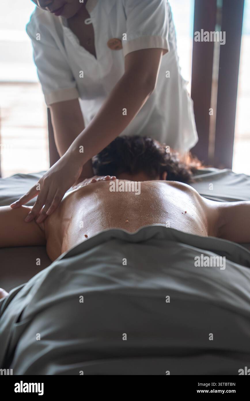 Spa thérapeute donne un massage à l'huile dans le spa de luxe Maldives Resort Banque D'Images