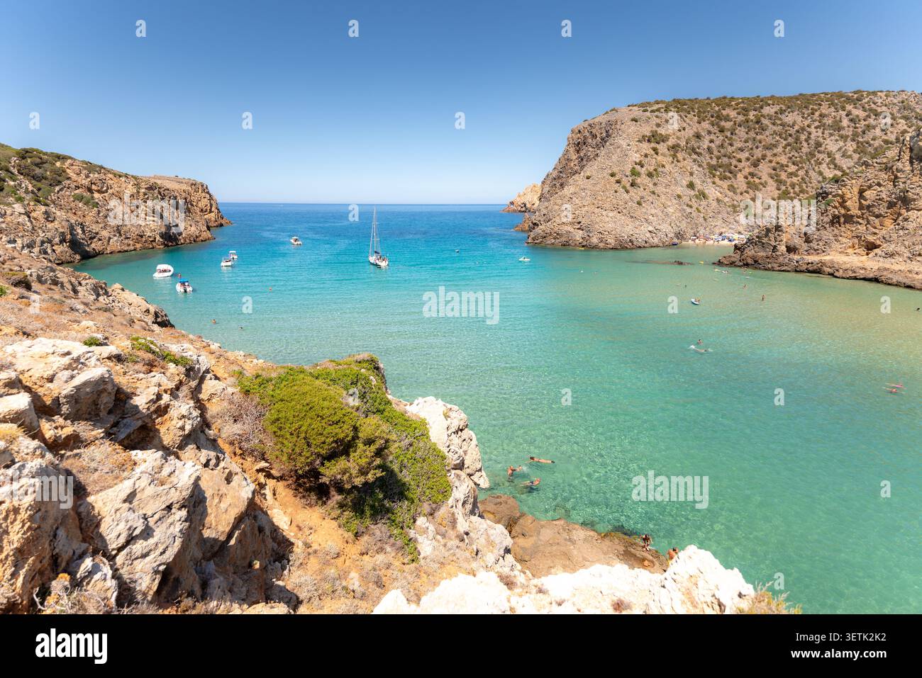 Les touristes profitent de l'eau cristalline et de la plage de Cala Domestica en Sardaigne, Italie Banque D'Images