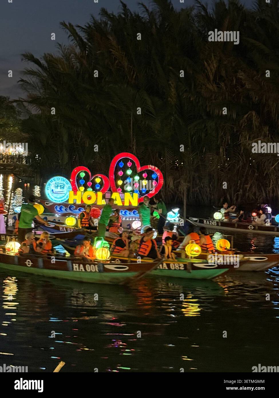 Hoi an est célèbre pour sa flottille nocturne de sampans (bateaux à fond plat) avec ses occupants lâchant de petites lanternes en papier flottantes colorées, chaque esprit - Image de stock capturée avec un smartphone