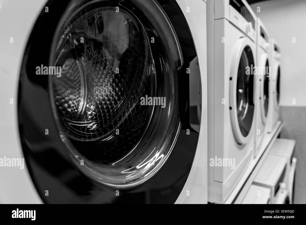 Machines à laver et sèche-linge commerciaux modernes dans un laverie publique. Équipement de blanchisserie industriel durable et écoénergétique. Banque D'Images