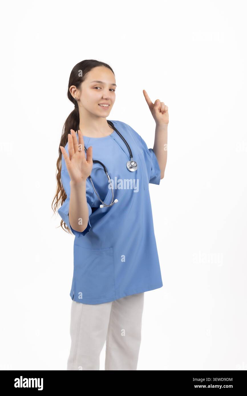 Infirmière joyeuse pointant du doigt la publicité du service de santé en studio Banque D'Images