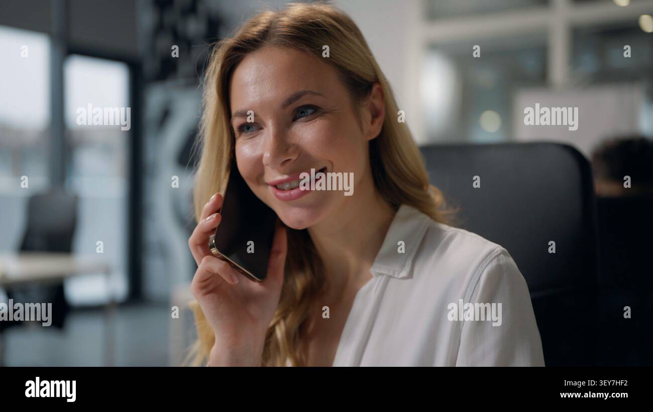 Femme d'affaires caucasienne adulte heureuse parlant téléphone mobile dans le bureau de l'entreprise souriante femme d'affaires joyeuse parler smartphone communiquant sourire milieu Banque D'Images