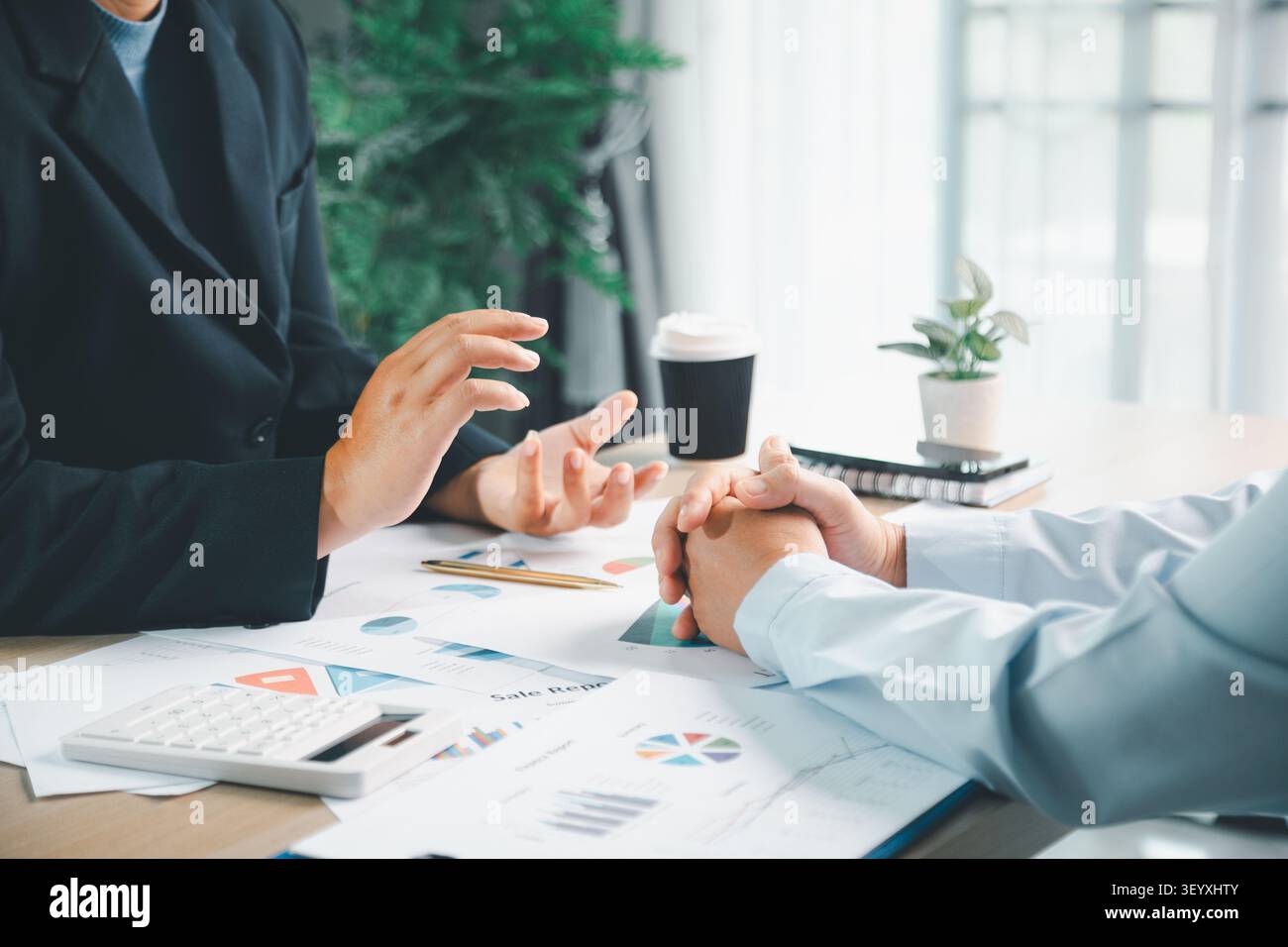 Équipe commerciale utilisant un ordinateur portable et une tablette dans un bureau moderne, représentant le flux de travail de la finance numérique, la gestion des rapports comptables et la collab d'affaires en ligne Banque D'Images