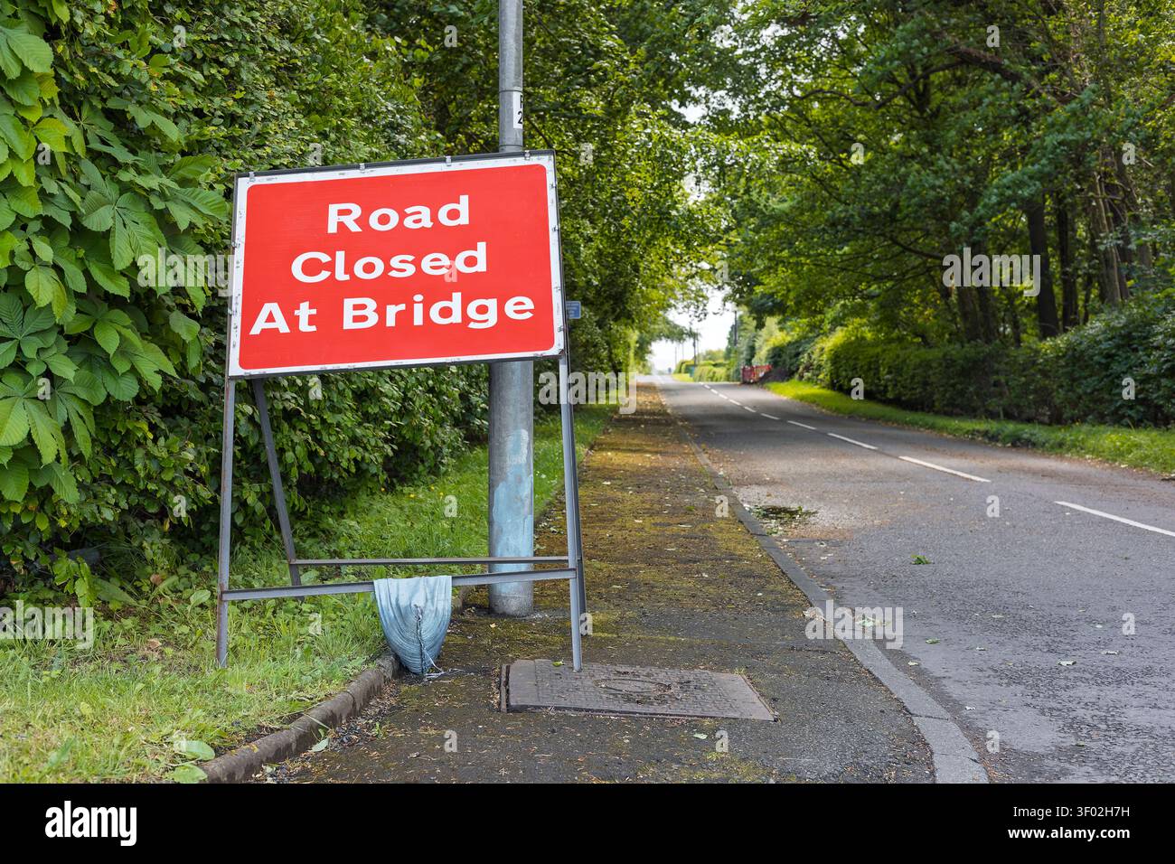 Panneau d'avertissement de fermeture temporaire de route avertissant les conducteurs de la fermeture d'un pont sur une route rurale tranquille pendant les travaux d'entretien et d'ingénierie Banque D'Images