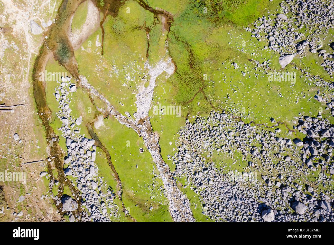 Une vue aérienne des prairies verdoyantes et du paysage rocheux entourant le lac Kareri à Dharamshala, en Inde. Banque D'Images