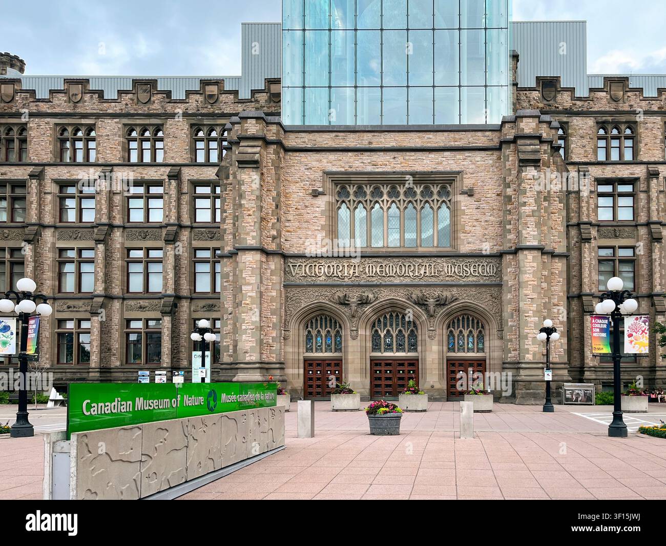 Ottawa, Ontario, Canada – 30 juin 2026 : Bâtiment historique en pierre du Victoria Memorial Museum avec une extension moderne en verre et le Musée canadien de la nature vert Banque D'Images