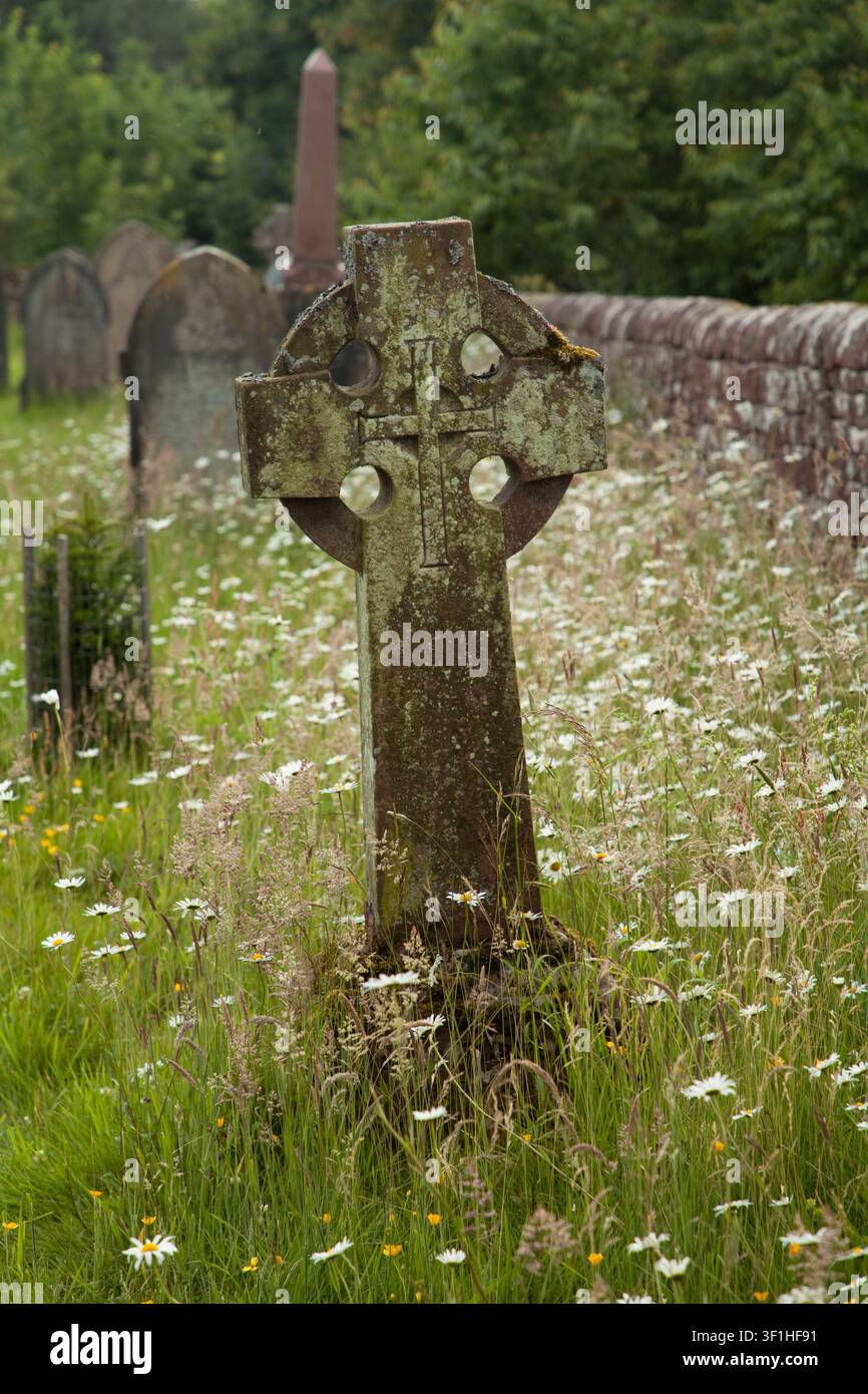 Une pierre tombale en forme de croix celtique dans le cimetière de St. Michaels et All Saints à Addingham près de Glassonby, Cumbria, Royaume-Uni Banque D'Images
