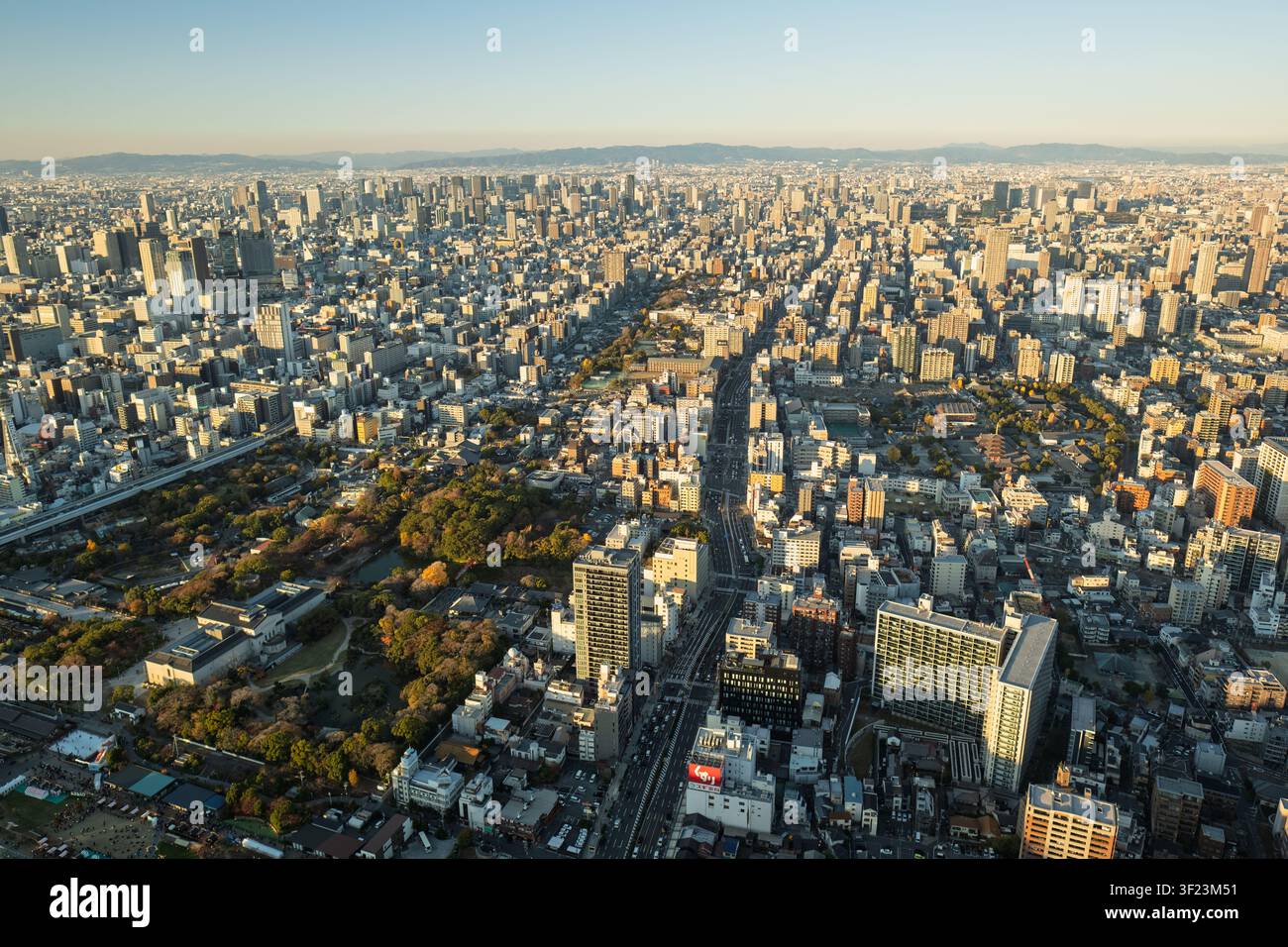 Vue large et élevée sur le vaste paysage métropolitain et la grille des rues d'Osaka s'étendant jusqu'à l'horizon lointain, Japon. Banque D'Images