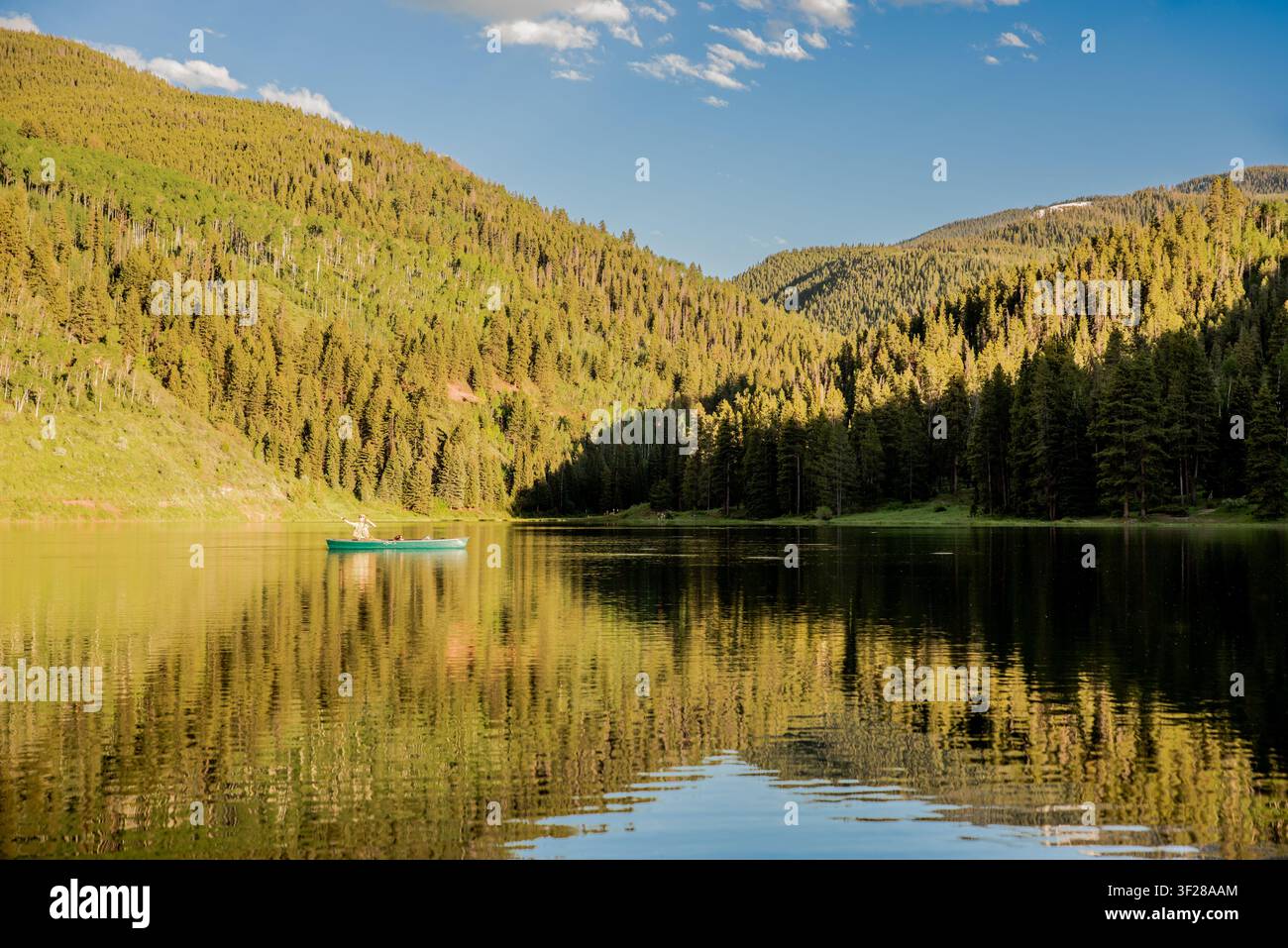 Personne pêchant depuis un canoë sur un lac tranquille Banque D'Images