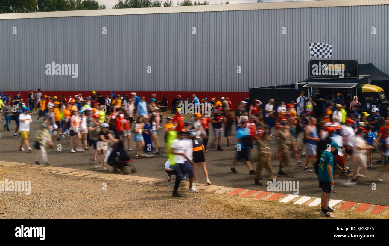 Les fans se rendant à la course du Grand Prix britannique dimanche à Silverstone, avec des foules traversant la zone du circuit avant le début du Grand Prix Banque D'Images