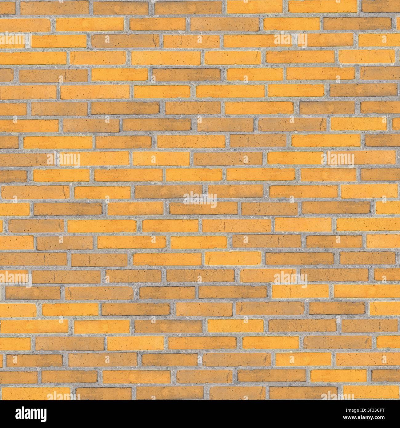 Un mur de briques mélangées jaune vif et brun, offrant une texture de surface chaude et graphique. Banque D'Images