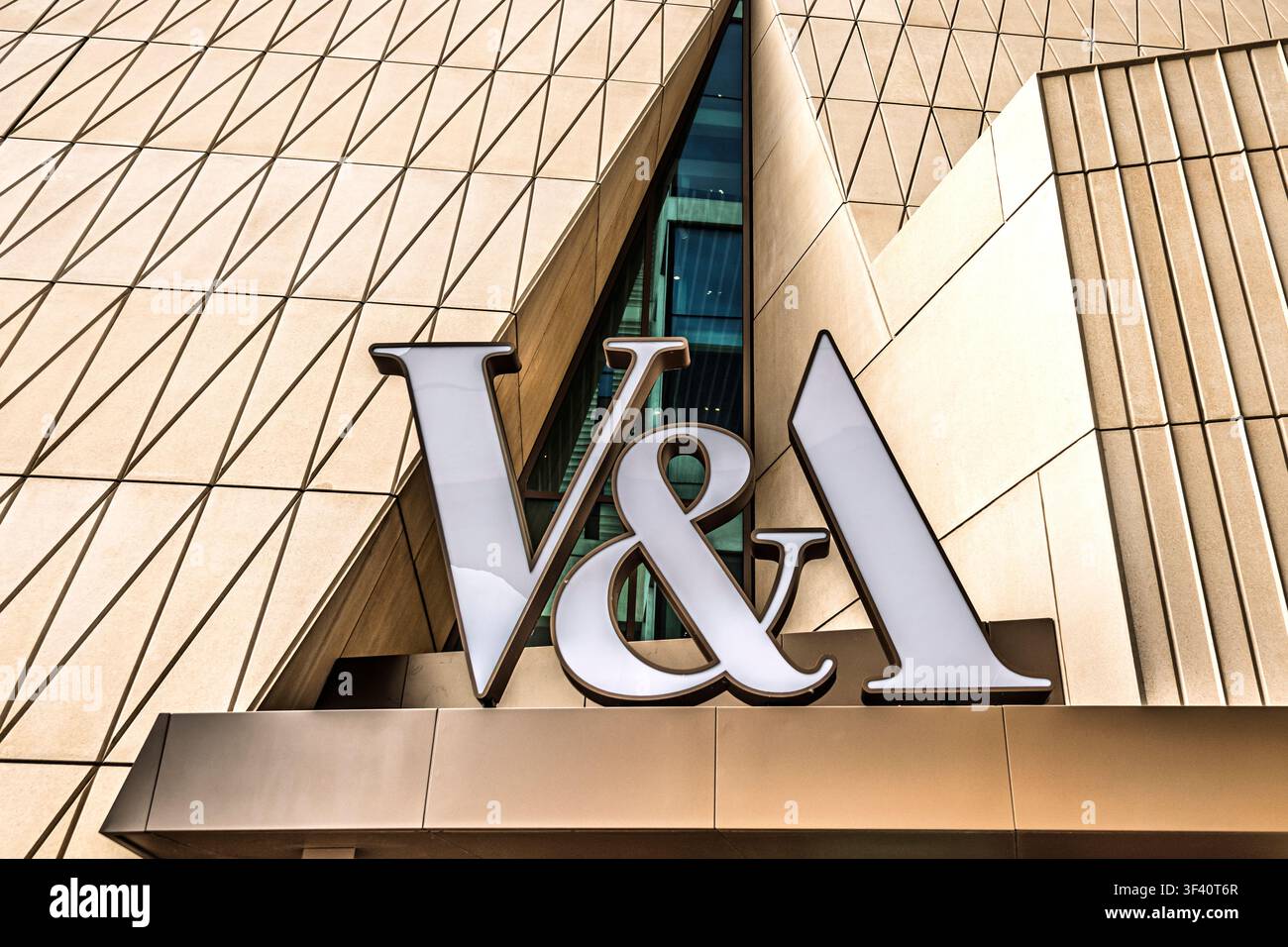 L'entrée du musée V&A East présente une signalétique géométrique audacieuse contre une façade métallique linéaire frappante dans un style architectural contemporain. Banque D'Images