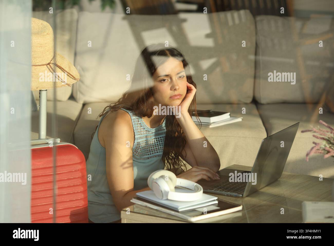 Étudiant triste et submergé étudiant en vacances dans une chambre d'hôtel Banque D'Images