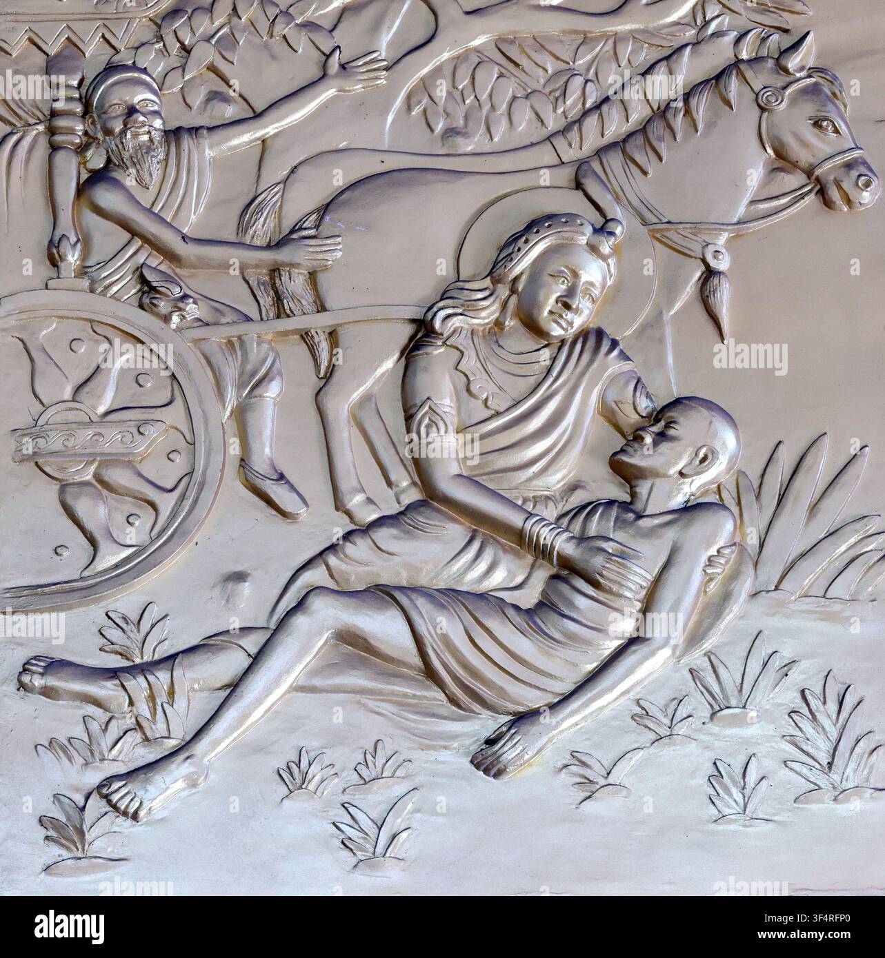 Pagode Xa Loi. Cette sculpture en relief représente une scène de compassion dans laquelle Siddhartha Gautama vient en aide à un homme. Ho Chi Minh Ville, Vietnam. Banque D'Images