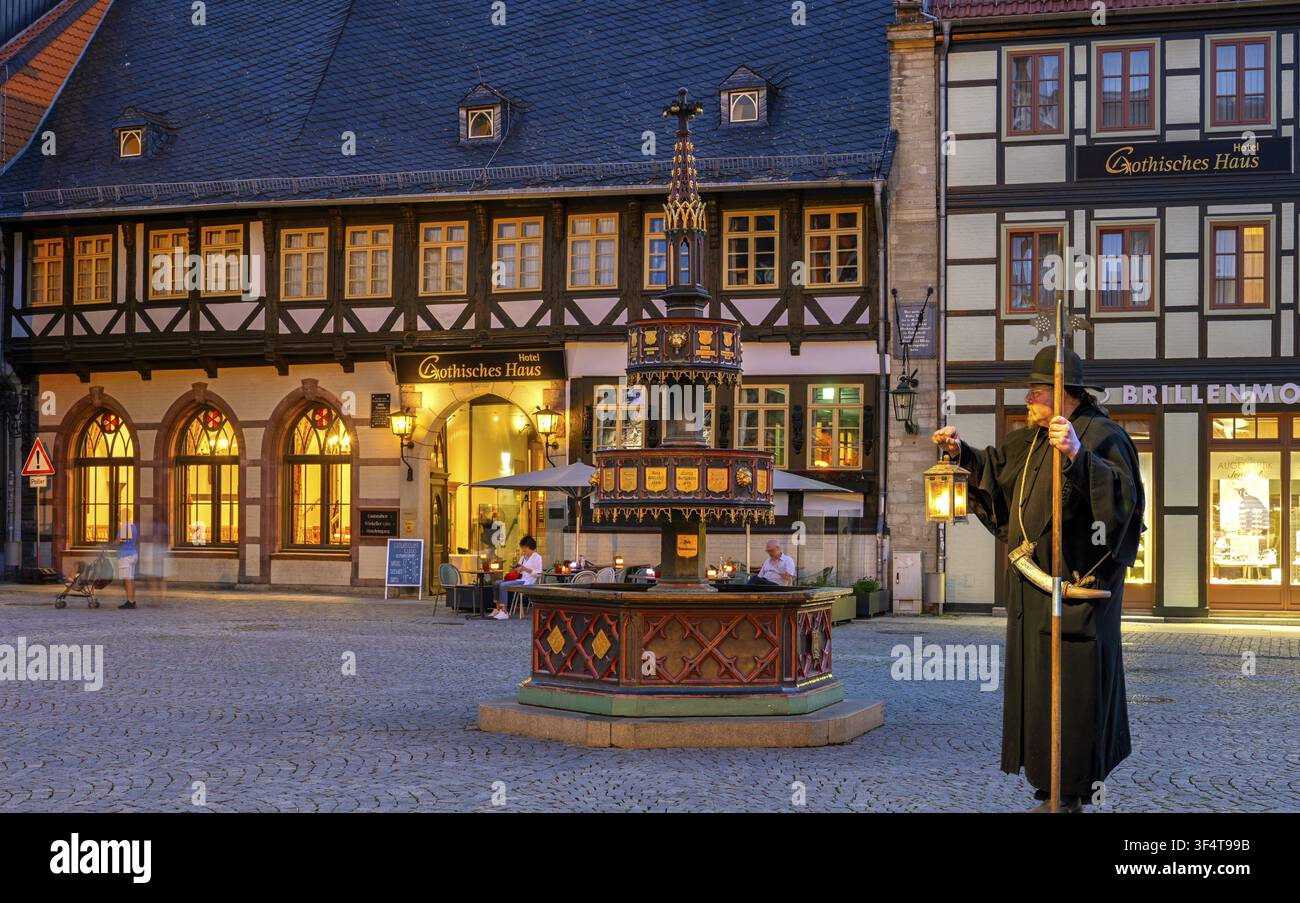 Gardien de nuit devant la fontaine Wohntaeterbrunnen illumine Wernigerode Harz Allemagne Banque D'Images