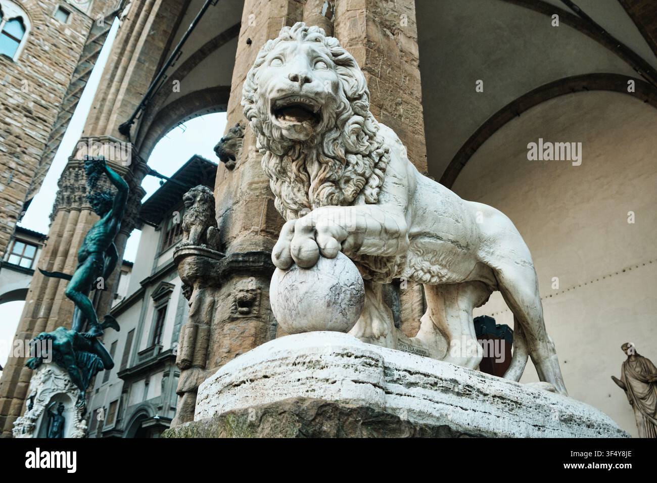 Florence, Italie - Mai 2026 : Statue en marbre du Lion Medici et sculpture de Persée portant la tête de Méduse à la Loggia dei Lanzi Banque D'Images