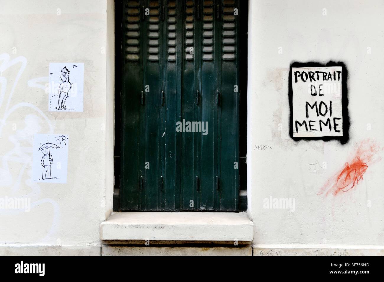 Divers éléments d'art de rue, notamment de petites illustrations collées en noir et blanc à gauche et une estampe encadrée portant l'inscription "PORTRAIT DE MOI MEME" Paris Banque D'Images