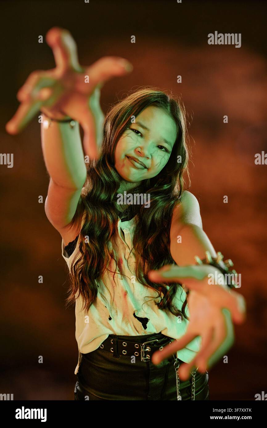 Portrait d'une fille asiatique tendant la main pendant une fête d'Halloween Banque D'Images
