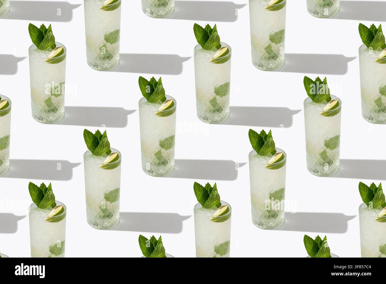 Cocktails Mojito rafraîchissants avec citron vert et menthe en motif répétitif sur fond blanc Banque D'Images