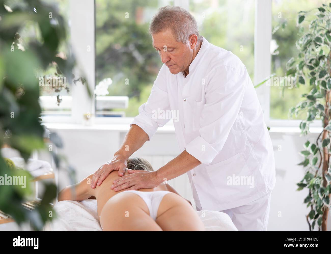 masseur masculin donnant massage à la patiente Banque D'Images