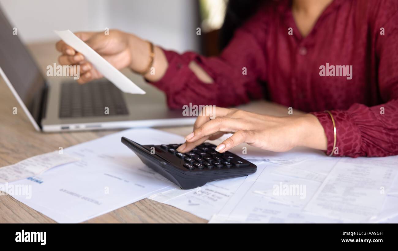 Femme calculant ses dépenses mensuelles avec des factures et des reçus, gros plan Banque D'Images