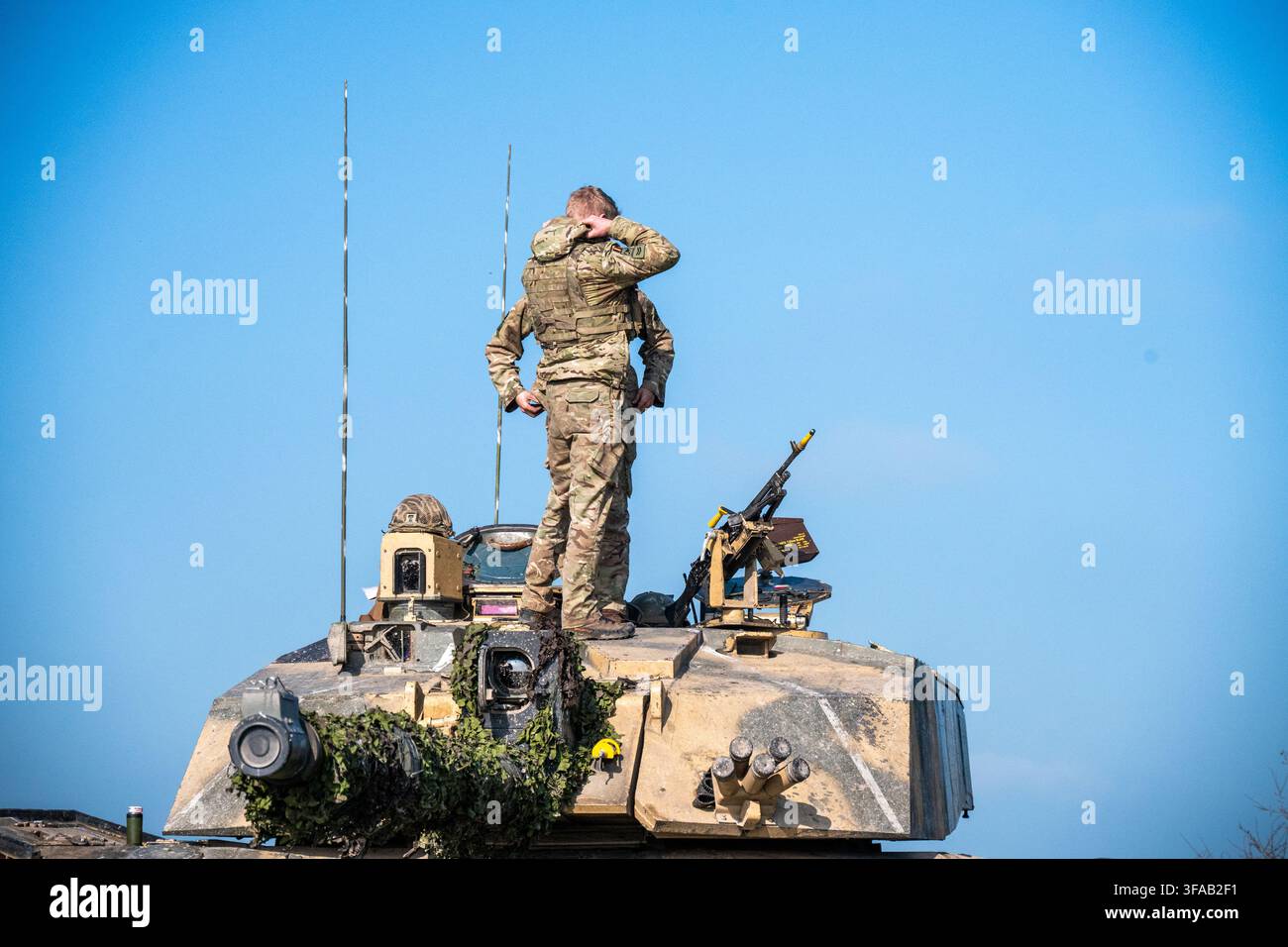 Vue d'un soldat en uniforme de camouflage debout au sommet d'un char de l'armée britannique sur la Salisbury Plain, Salisbury, Wiltshire, Royaume-Uni. Banque D'Images