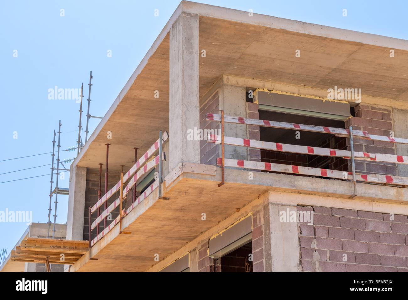 Un bâtiment résidentiel ou commercial à plusieurs étages en phase de construction précoce, mettant en valeur le béton brut et la maçonnerie Banque D'Images