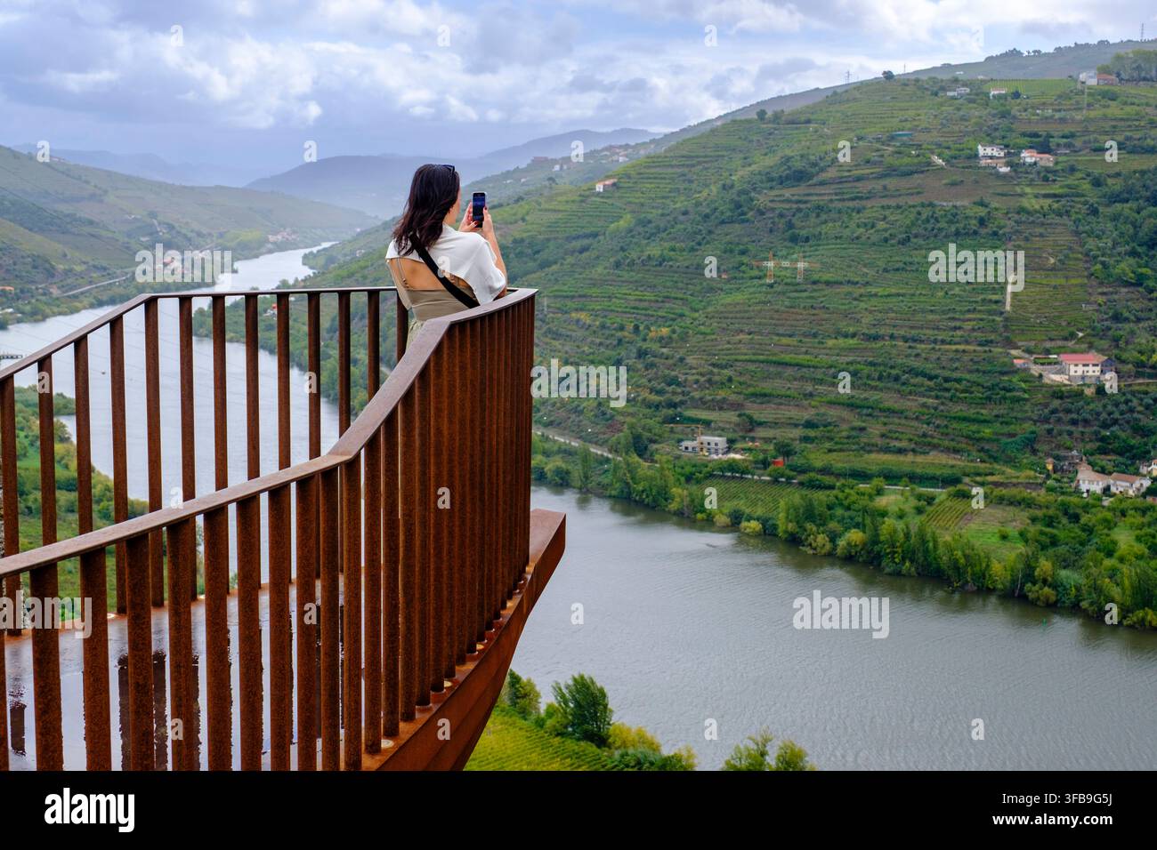 Femme prenant une photo au Miradouro do Imaginario dans la vallée du Douro, point de vue avec vue sur le fleuve Douro, Portugal Banque D'Images