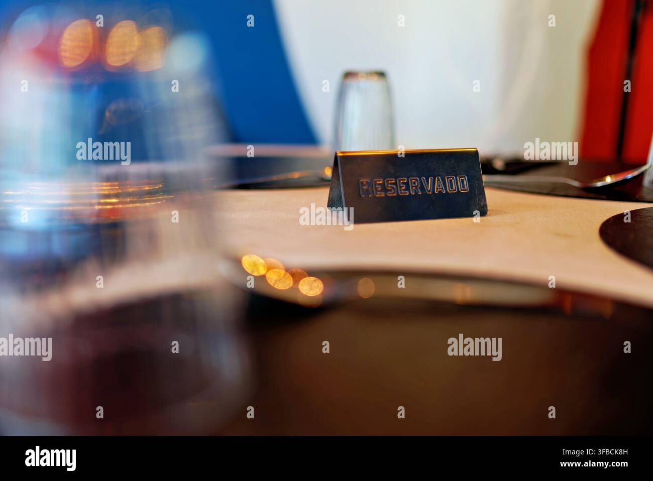 Panneau réservé sur une table de restaurant avec couverts et verres. Banque D'Images
