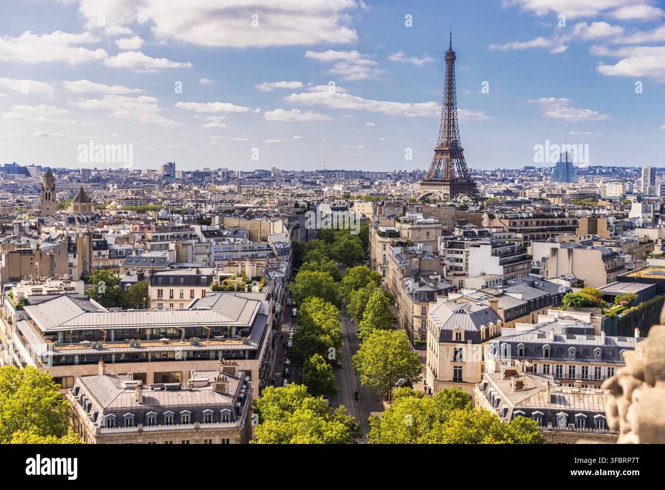 Vue aérienne de la Tour Eiffel et des toits de ville haussmanniens depuis l'Arc de Triomphe à Paris. Vue panoramique élevée sur les avenues bordées d'arbres Banque D'Images