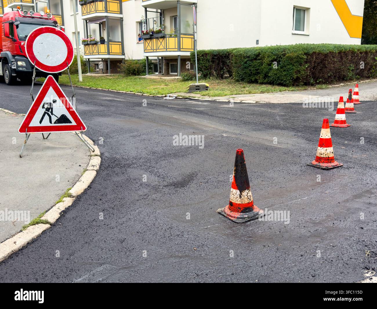 Surface d'asphalte noir fraîche sur une route urbaine rénovée – Chantier de construction Banque D'Images