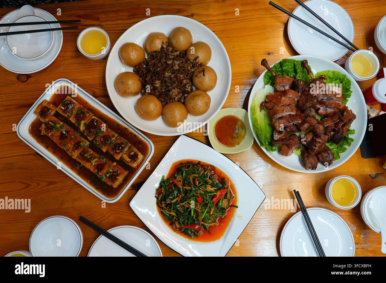 Table de restaurant avec de nombreux plats dans les régions rurales de Guangdong, en Chine. Cuisine cantonaise et cuisine hunan. Tofu farci, waipo cai, cuisses de canard et légumes sautés Banque D'Images