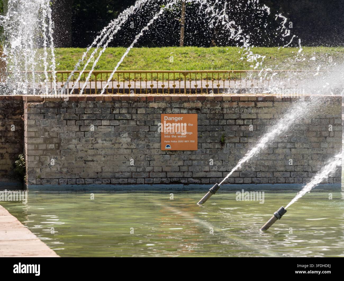 Jets d'eau et panneau d'avertissement aux fontaines du Battersea Park à Londres, Angleterre, Royaume-Uni. Banque D'Images