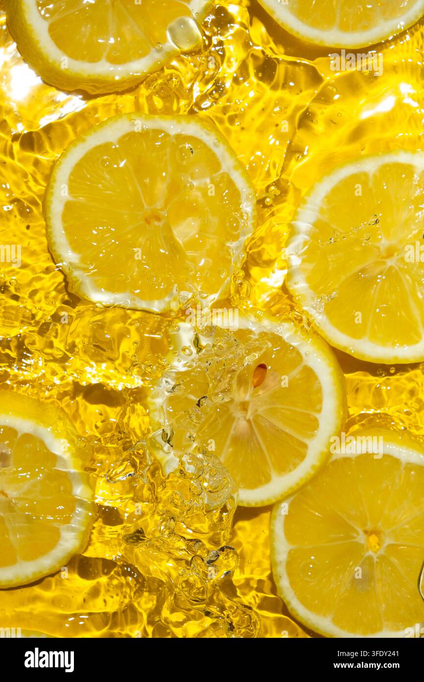 Tranches de citron juteuses dans l'eau vues du dessus Banque D'Images