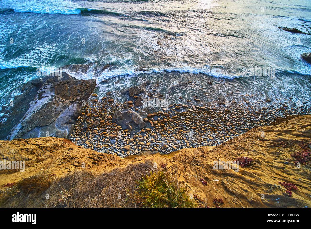 Falaises surplombant une plage rocheuse et les vagues de l'océan aux Sunset Cliffs en Californie Banque D'Images