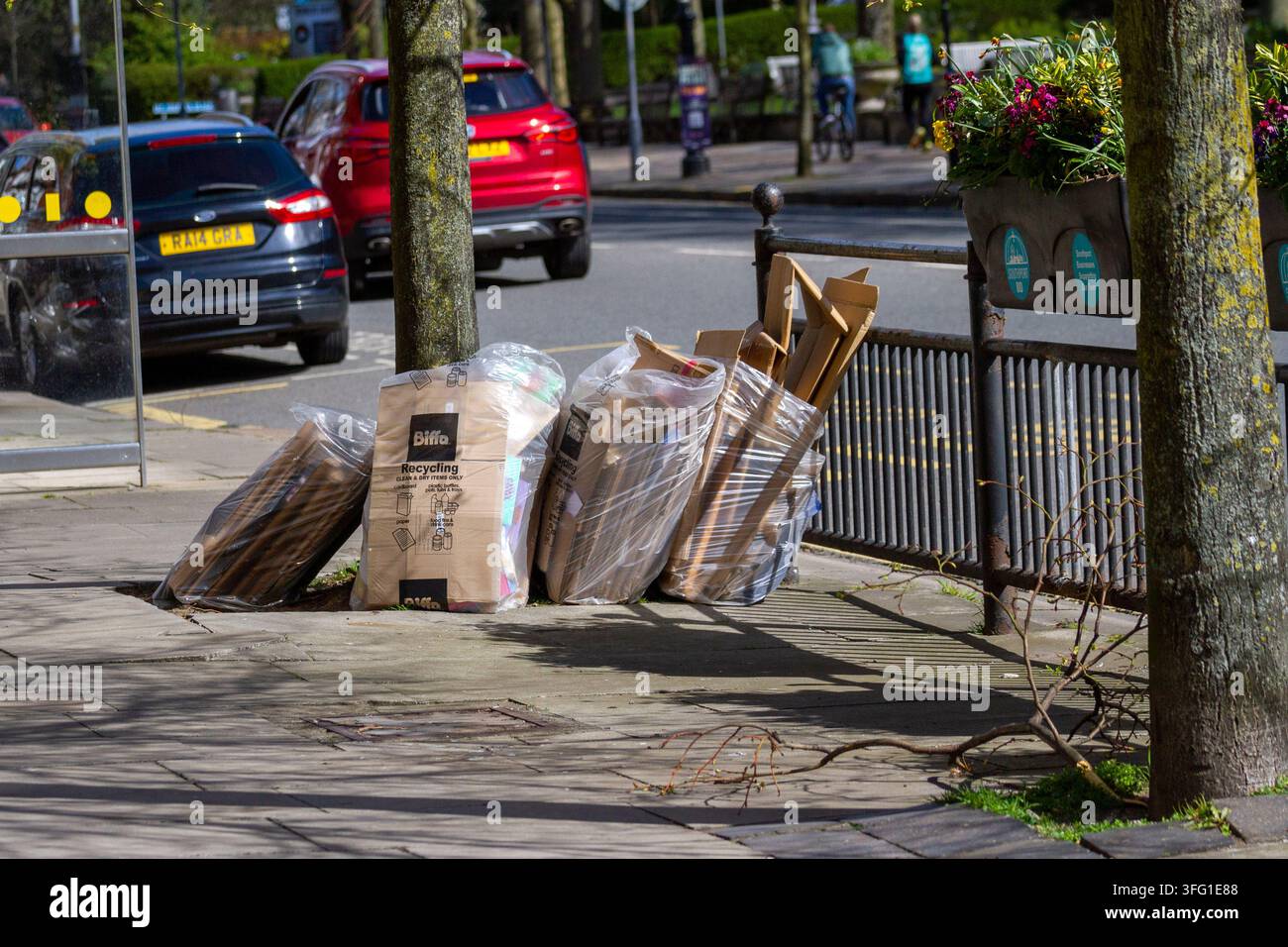 Des piles de déchets de carton commerciaux de Biffa sont empilées sur le trottoir près d'un arrêt de bus dans une rue publique. Southport, Royaume-Uni. Banque D'Images