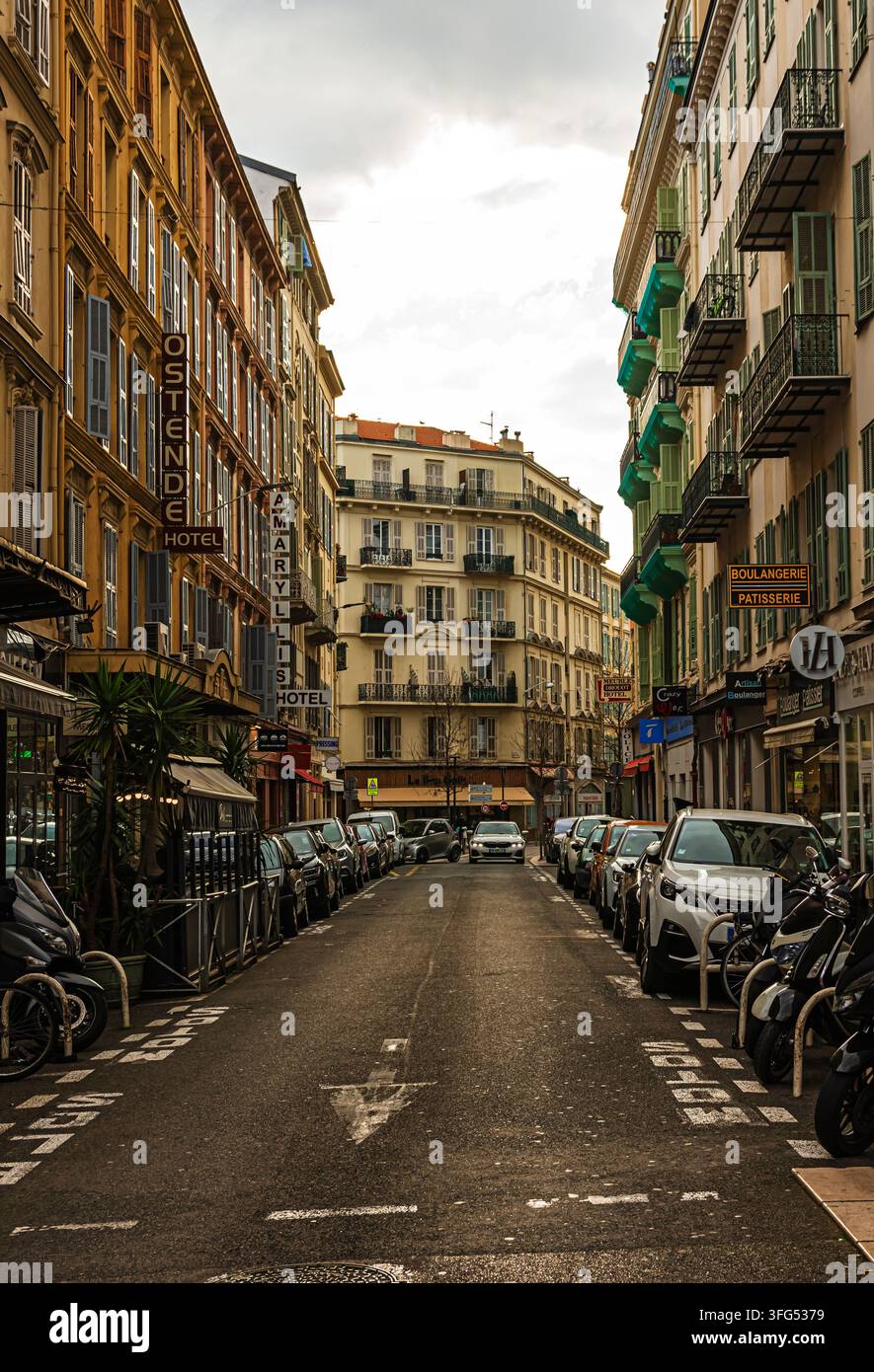 une rue à Nice entourée de bâtiments historiques et de véhicules garés sur les côtés Banque D'Images