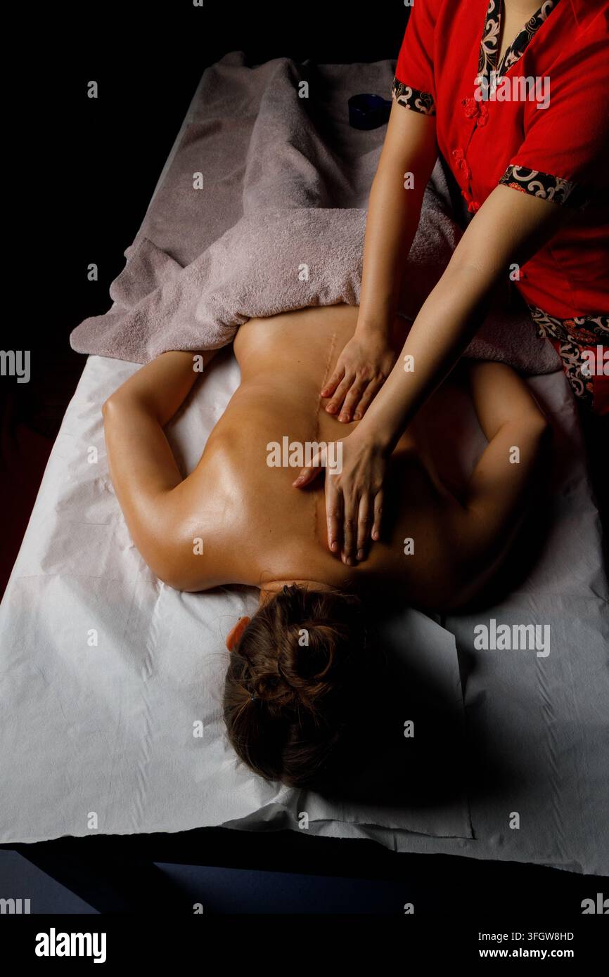 Thérapeute donne un massage relaxant du dos dans un spa Banque D'Images
